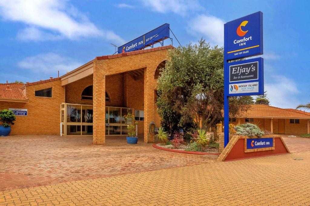 
a large blue and white building with a sign on the side of it at Comfort Inn Bay of Isles in Esperance
