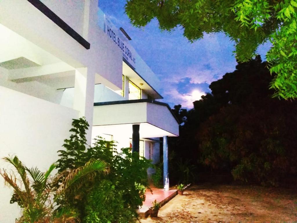 a white building with the sky in the background at Hotel Blue Coral Rameswaram in Rāmeswaram