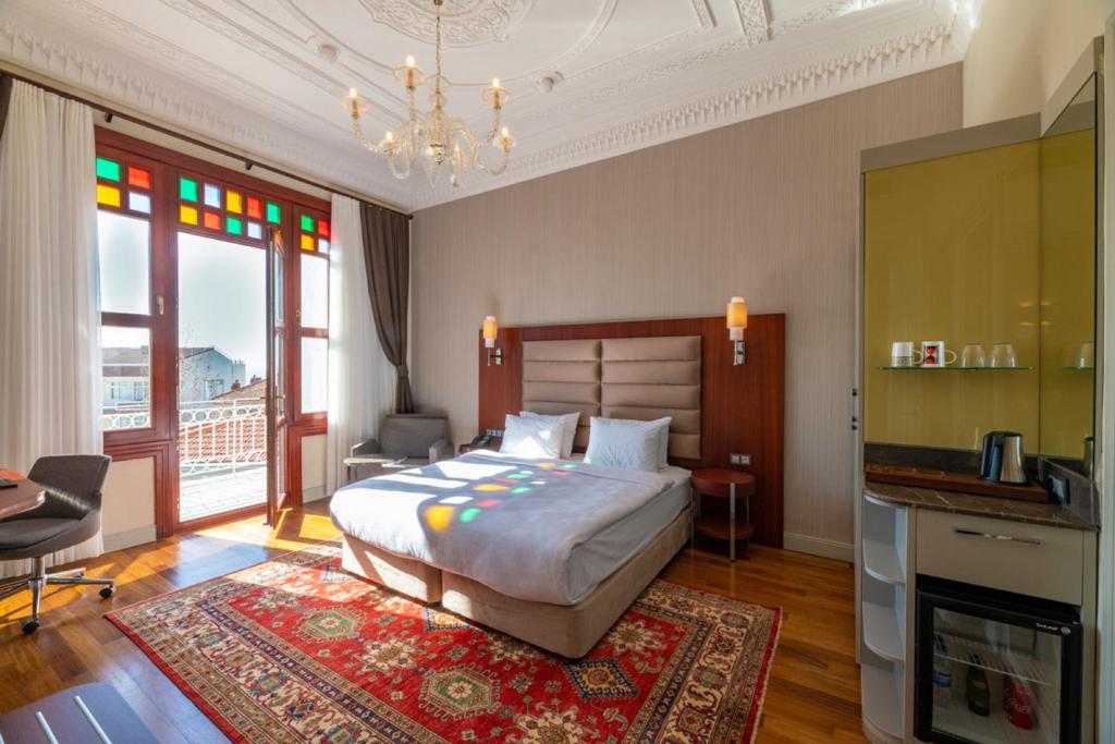 a bedroom with a bed and a chandelier at Blue Gilroy Hotel in Istanbul