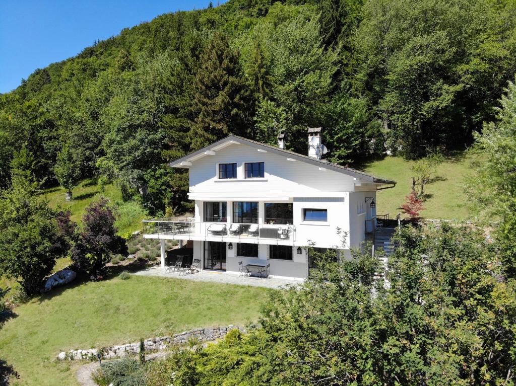 an aerial view of a white house on a hill at Vue exceptionnelle sur lac d'Annecy et Montagnes in Menthon-Saint-Bernard