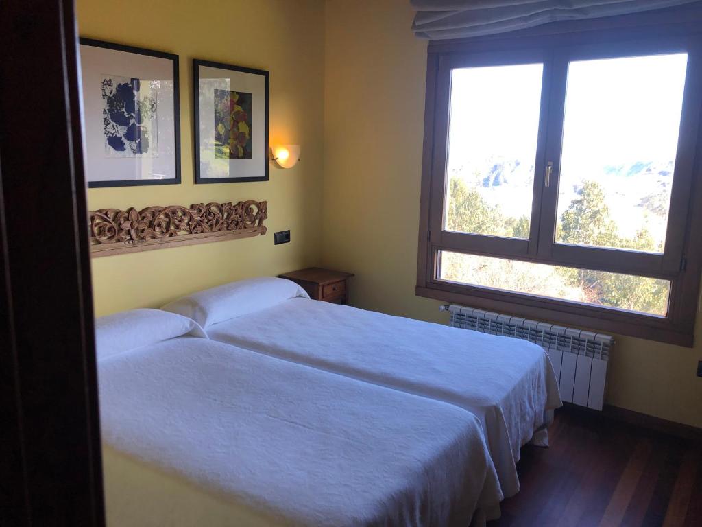 Postel nebo postele na pokoji v ubytování Apartamentos Monterodiles
