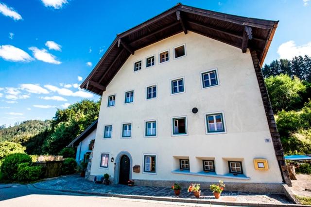 a large white house with a brown roof at Taverne Vachenlueg in Anger