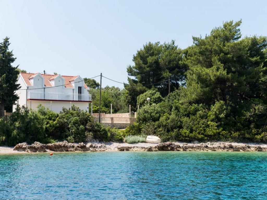 a house on the shore of a body of water at Holiday Home Macus in Koločep