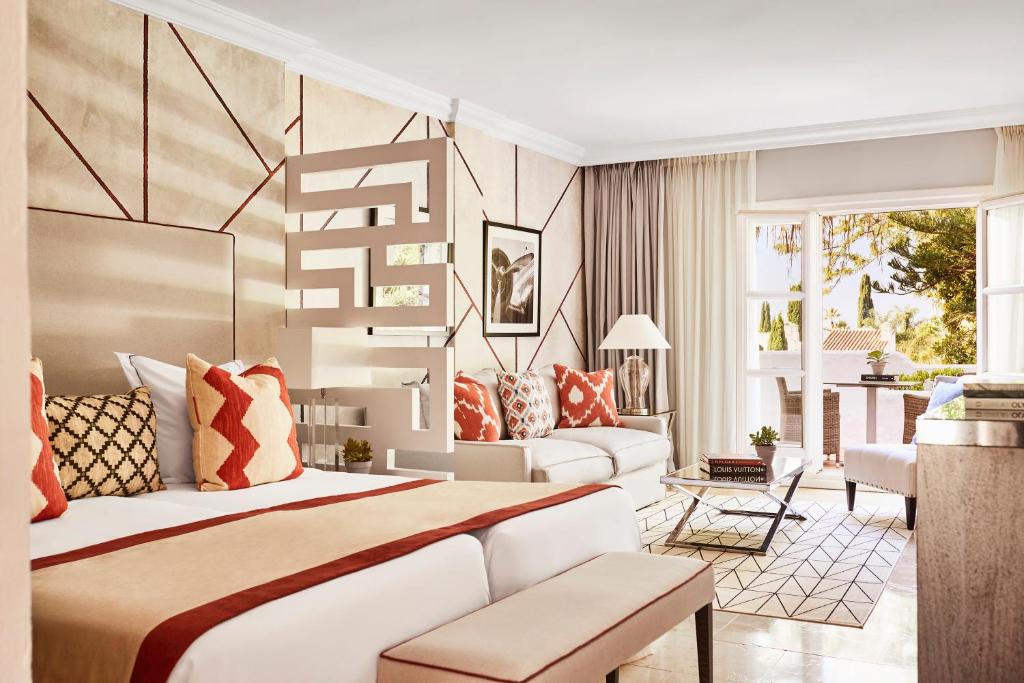 a bedroom with a bed and a living room at Puente Romano Marbella in Marbella