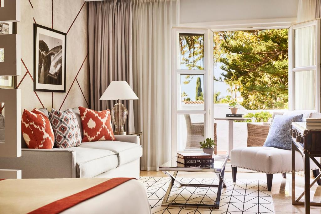 a living room with a couch and a chair at Puente Romano Marbella in Marbella
