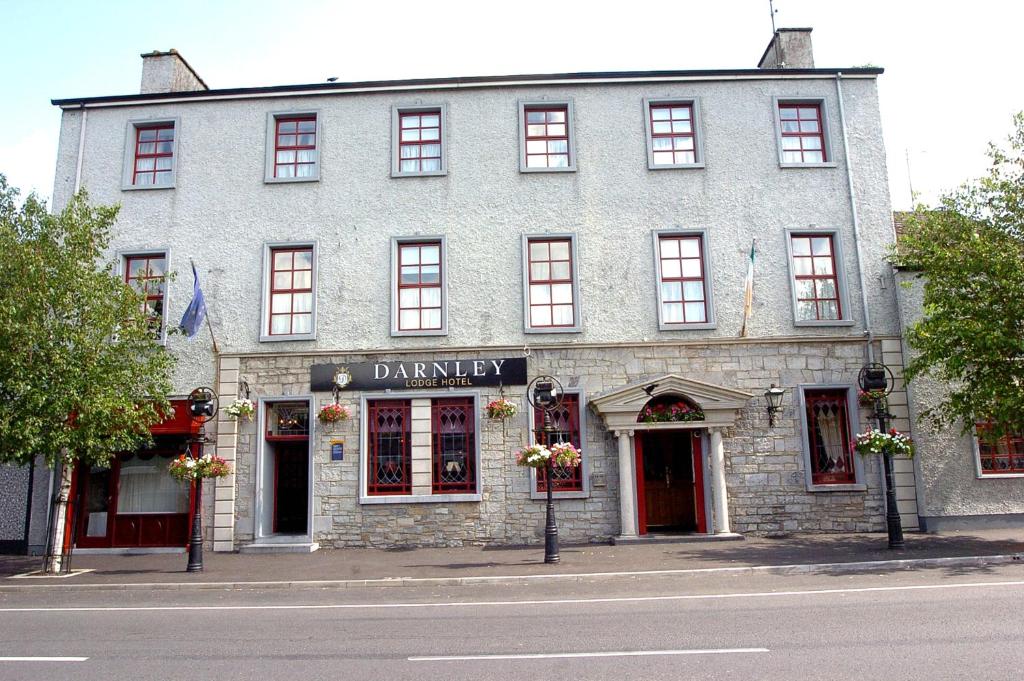 a gray building on the corner of a street at Darnley Lodge Hotel in Athboy