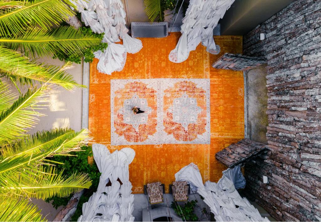an overhead view of a building with a clock on it at Casa Malca in Tulum