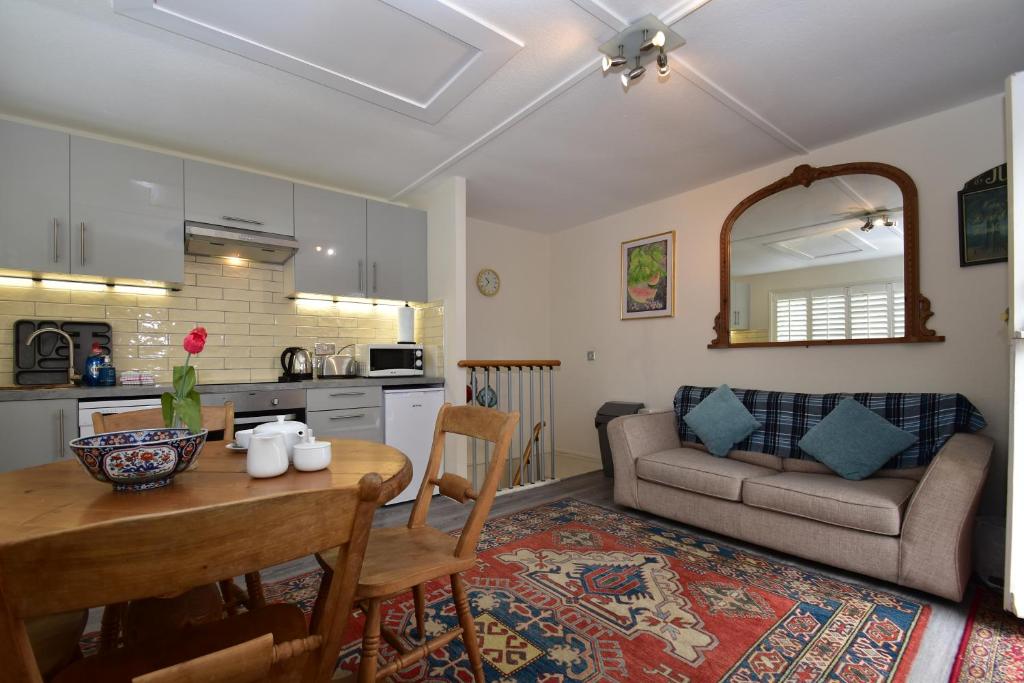 a kitchen and living room with a table and a couch at Studio 22 in Rye