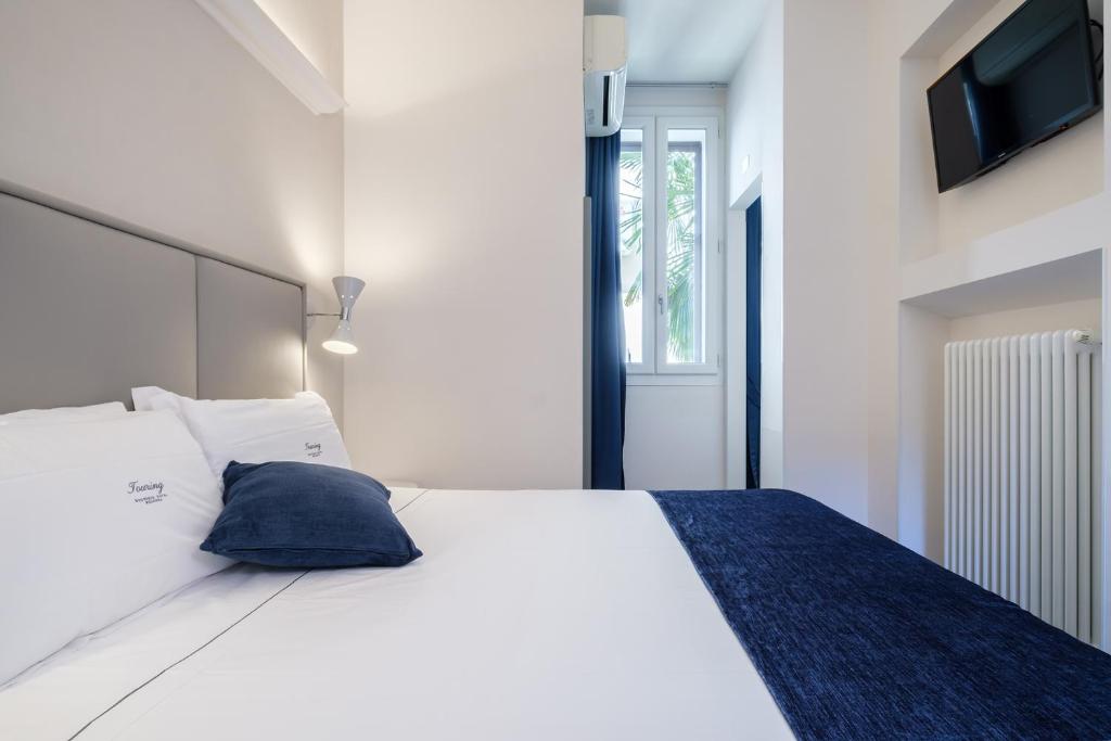 Postel nebo postele na pokoji v ubytování Hotel Touring