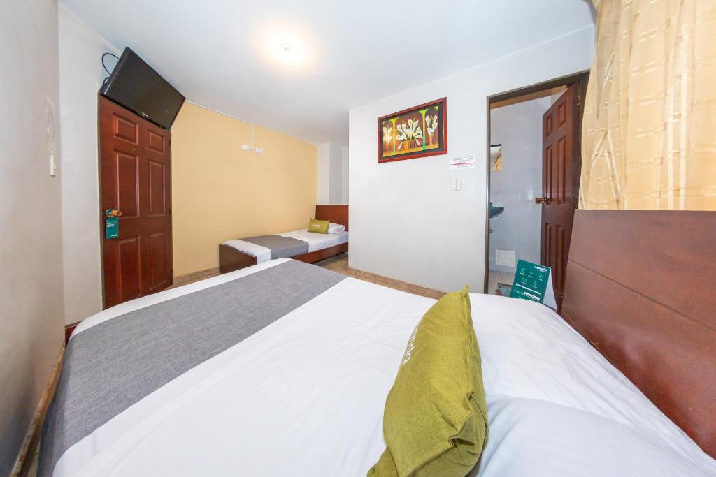 Postel nebo postele na pokoji v ubytování Hotel Home Bioma 1010