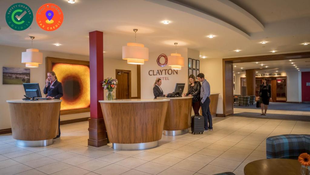 a lobby with people standing at a counter in a hotel at Clayton Hotel & Leisure Club Sligo in Sligo