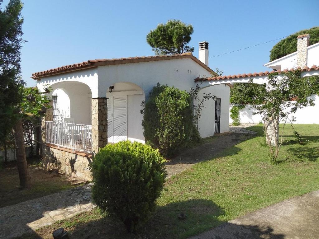 una casa blanca con una puerta y un patio en Montserrat I, en L'Escala