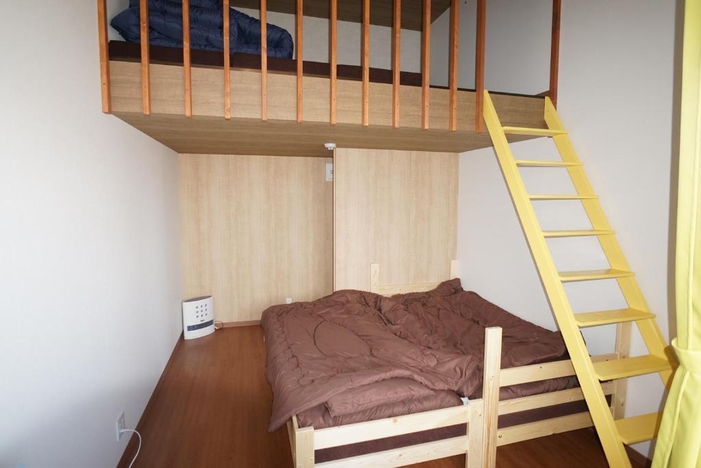 a bedroom with a bunk bed and a ladder at Guest House Ihatov - Vacation STAY 22102v in Takamatsu