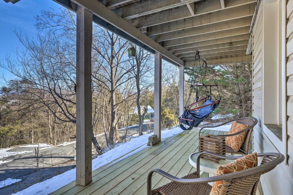 a porch with two chairs and a hammock on it at Massanutten Retreat with Double Deck and Mtn View! in McGaheysville