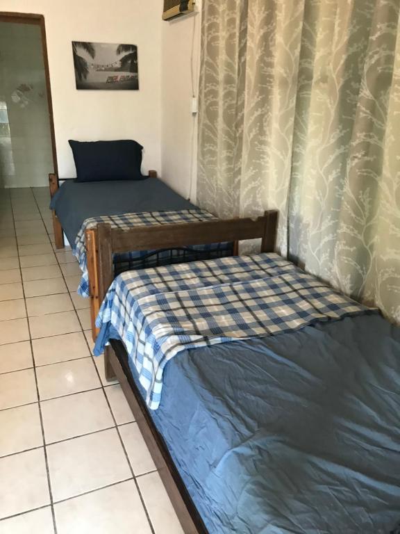 Postel nebo postele na pokoji v ubytování Combate Green House