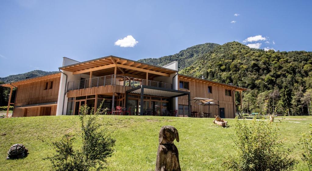 een huis op een heuvel met bergen op de achtergrond bij Bosc del Meneghì in Ledro