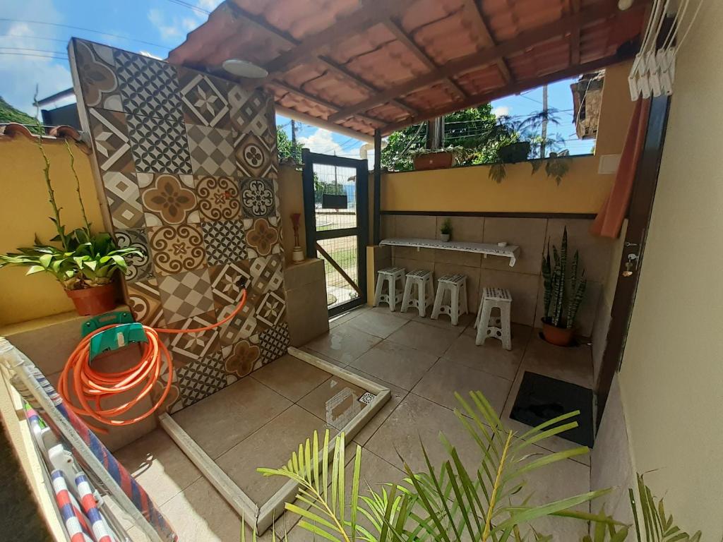 a view of a patio with a table and chairs at Suíte da Vila - Beira Mar in Abraão