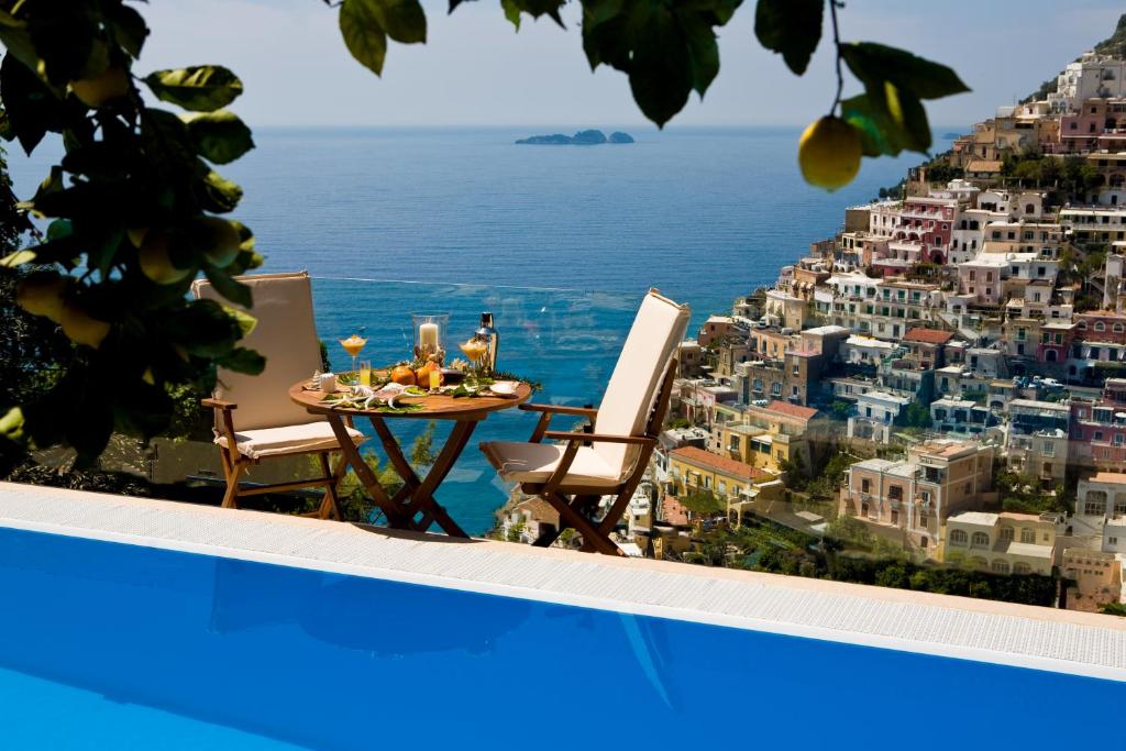 a table and chairs with a view of a city at Villa Fiorentino in Positano