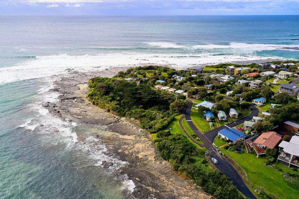 an aerial view of a beach with houses and the ocean at Marengo Family Caravan Park in Marengo