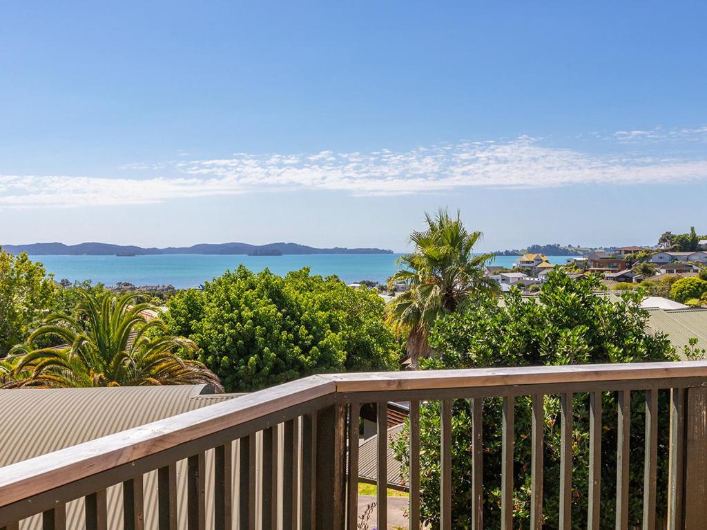 a balcony with a view of the ocean at Kawau Vista - Snells Beach Holiday Home in Snells Beach