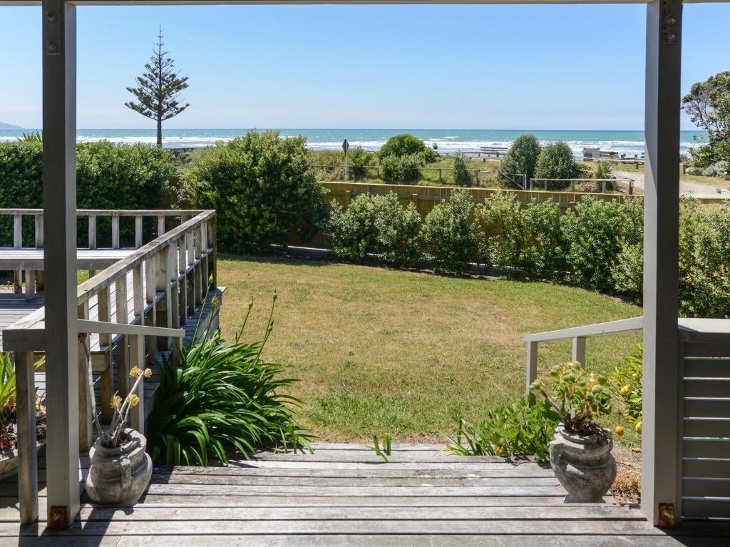 a view from the porch of the beach house at Bach 112 - Waimarama Holiday Home in Waimarama