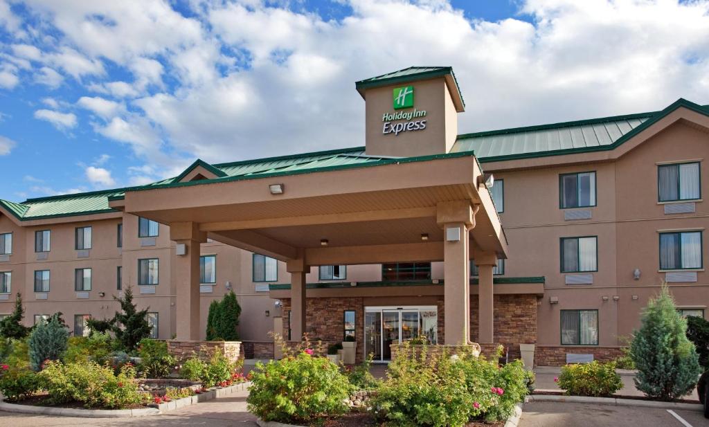 a hotel with a sign on top of a building at Holiday Inn Express Hotel & Suites Vernon, an IHG Hotel in Vernon