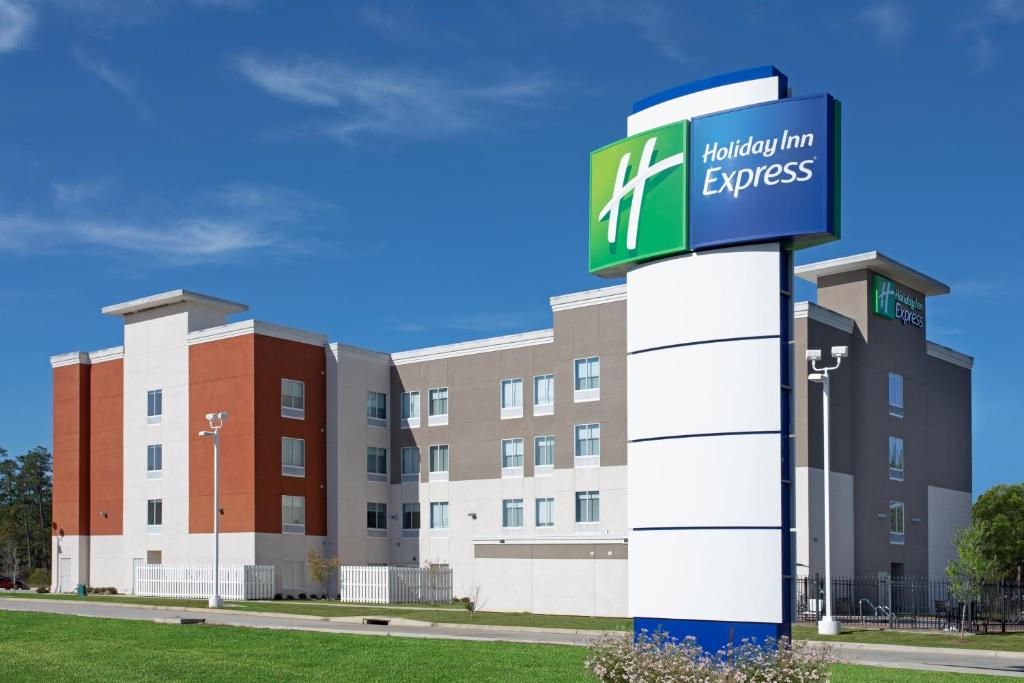 a building with a sign in front of it at Holiday Inn Express Slidell by IHG in Slidell