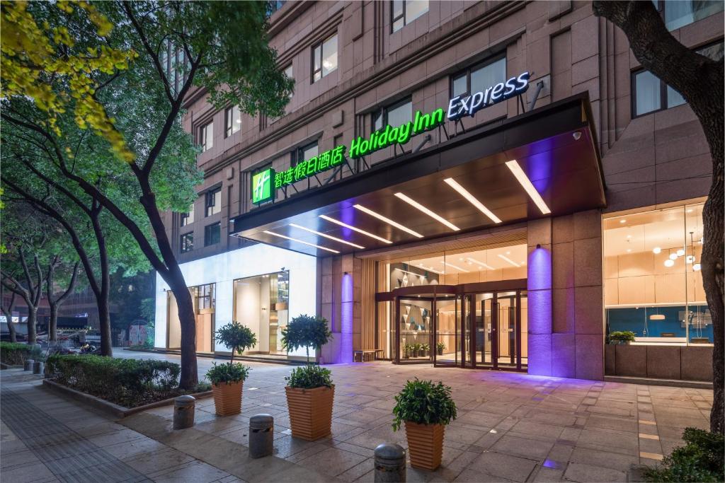 a store front of a building with purple lights at Holiday Inn Express Ningbo City Center by IHG in Ningbo
