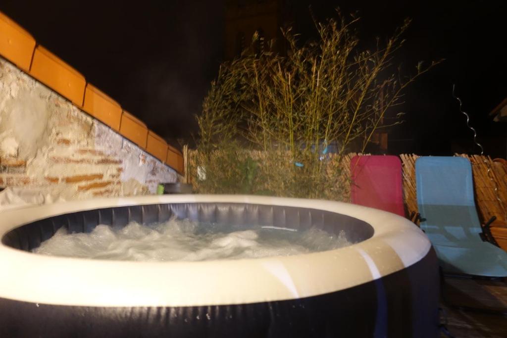 a large tub filled with water next to a wall at Maison Small Luxury ( planxa,suite,solarium,jacuzzi,pas de vis à vis) in Argelès-sur-Mer