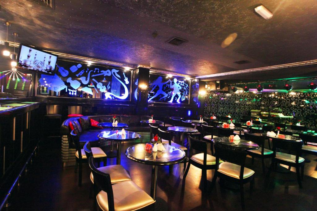 a restaurant with tables and chairs and a bar at Gulf Inn Hotel Deira Formerly City Star Hotel in Dubai