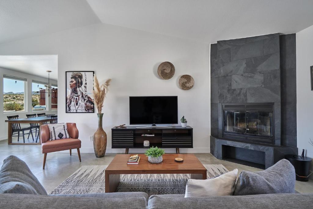 a living room with a couch and a fireplace at The Cherokee House in Joshua Tree in Joshua Tree