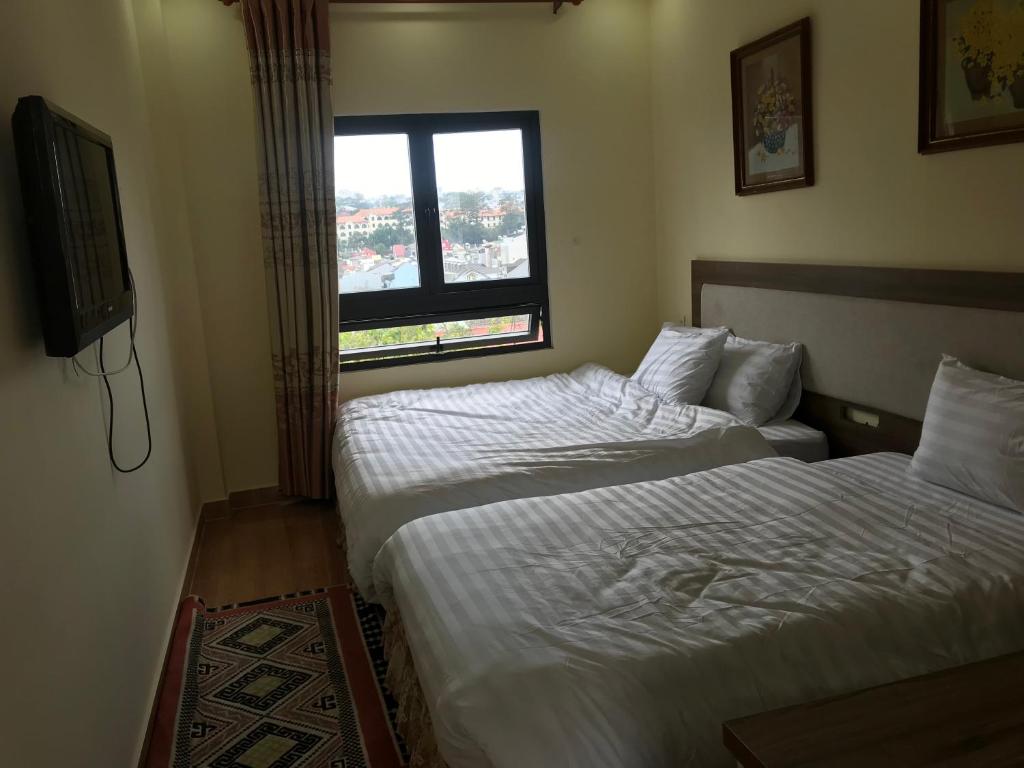 Postel nebo postele na pokoji v ubytování Ngoc Tran Hotel