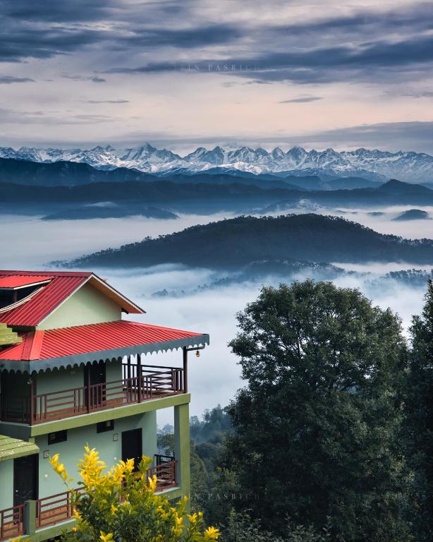 a house with a view of the mountains at Himalaya Darshan Resort in Kausani