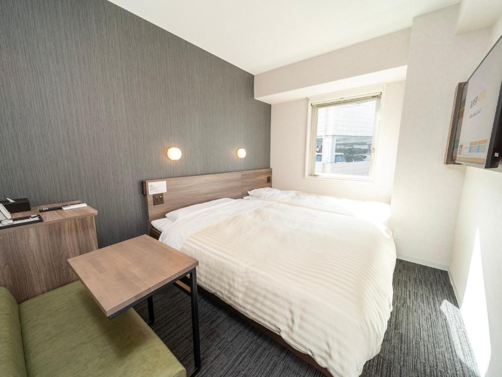 Postel nebo postele na pokoji v ubytování Super Hotel Hiroshima Yagenboridori