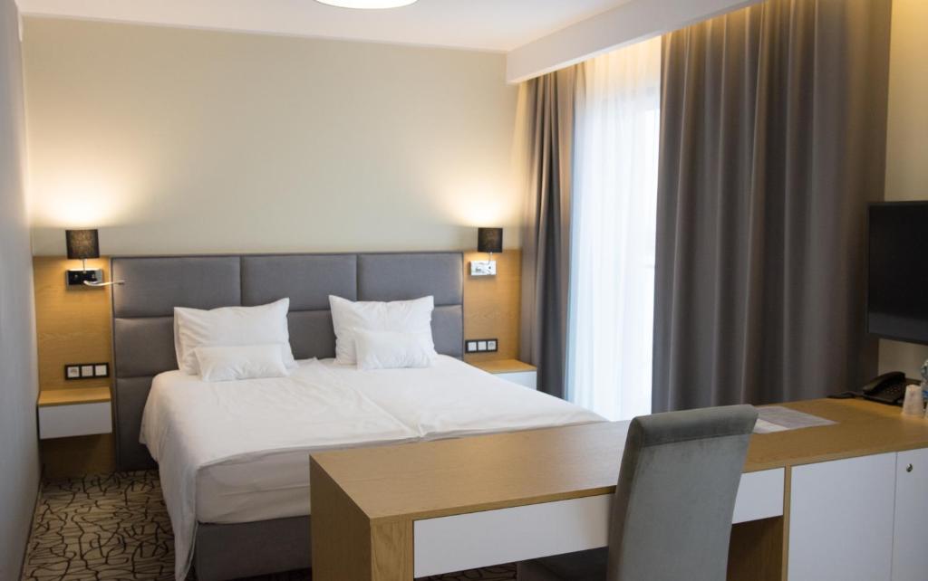 Postel nebo postele na pokoji v ubytování Aparthotel Termy Uniejów