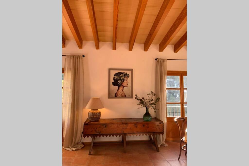 a living room with a table and a window at Casa Mistral, Un paraíso de Mar y Montaña in Valldemossa