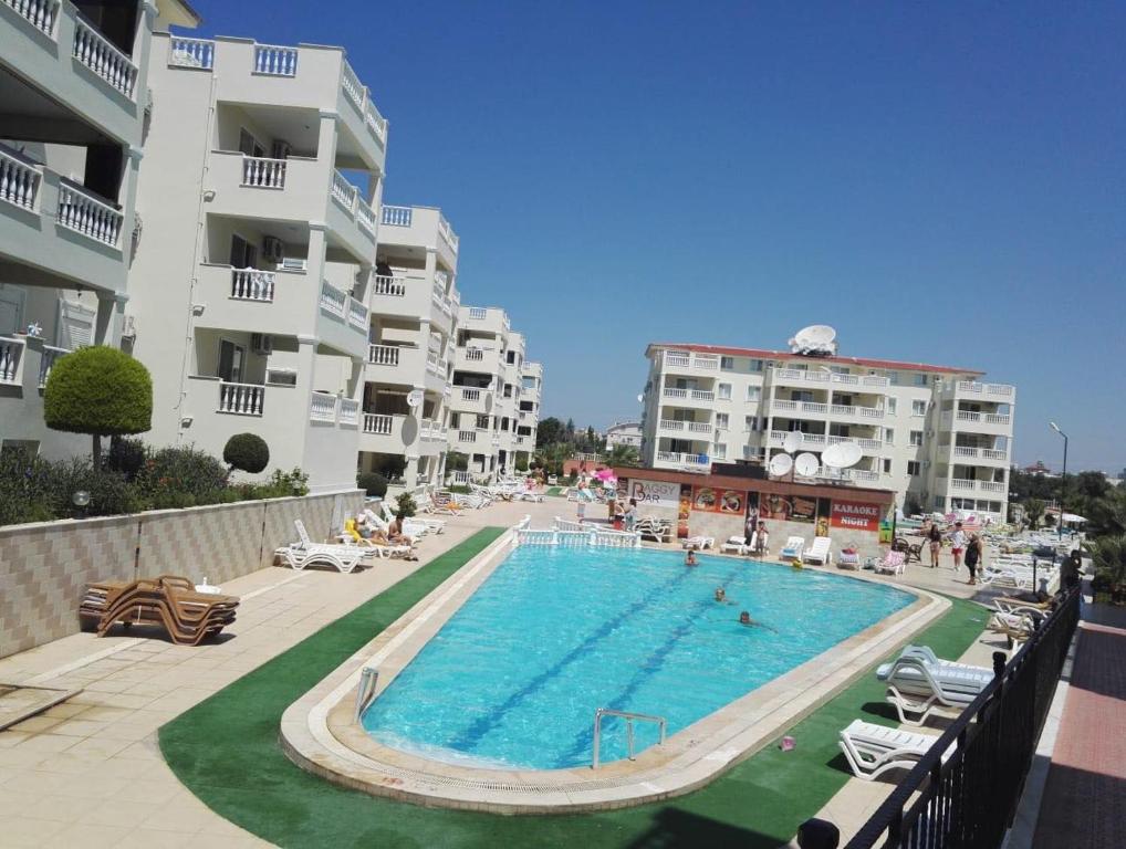 a swimming pool in front of some apartment buildings at Royal Marina in Didim