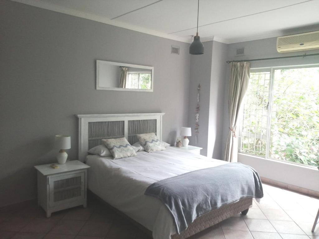 巴利托的住宿－84 Leonora Drive - Family Holiday Home，卧室配有白色的床和窗户。