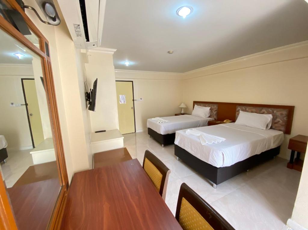 Postel nebo postele na pokoji v ubytování Jumbotel Hotel