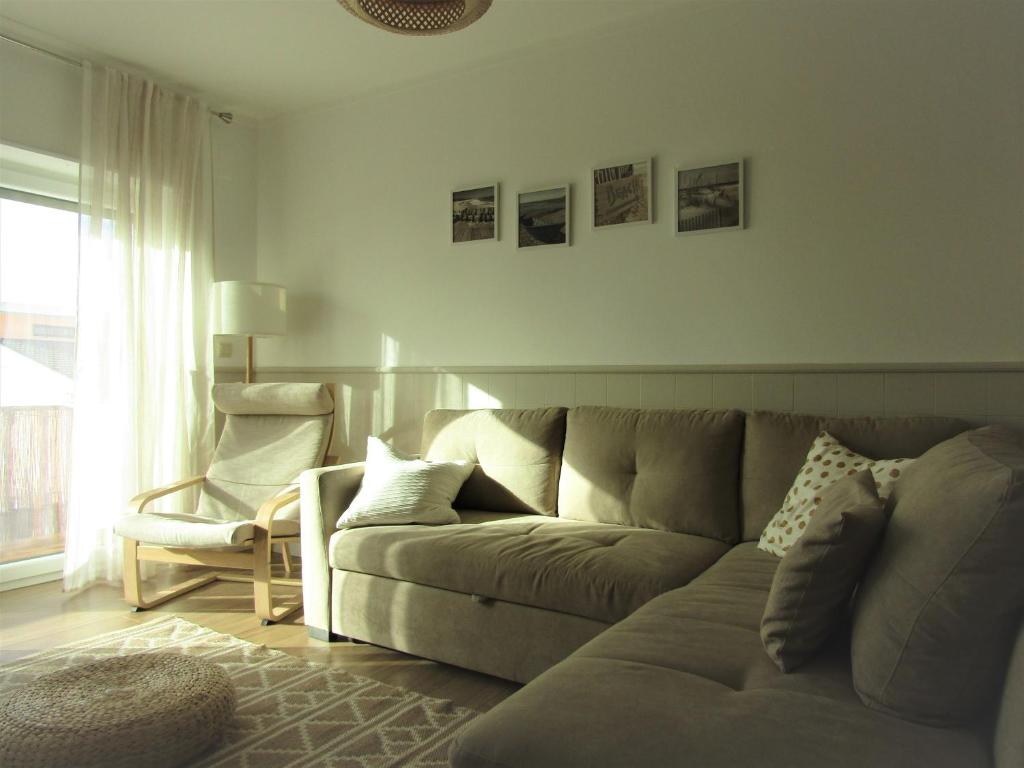 a living room with a couch and a chair at Pedras do Mar - Consolação - Peniche in Consolacao