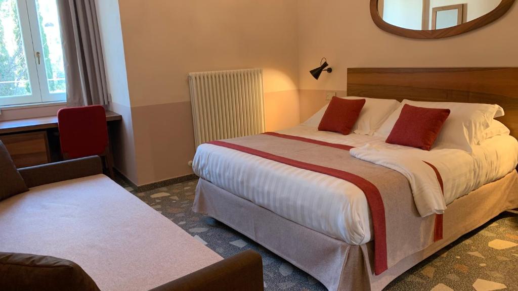 a bedroom with a large bed and a mirror at Dimora del Leone Gaeta in Gaeta
