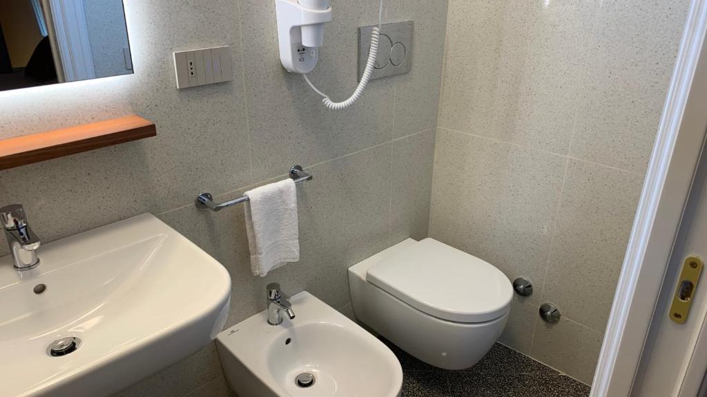 a bathroom with a white toilet and a sink at Dimora del Leone Gaeta in Gaeta