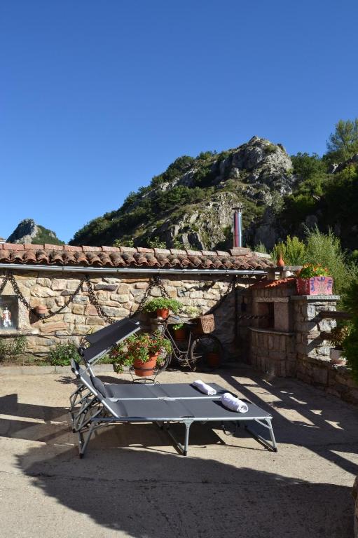 a bench sitting in front of a stone building at La Cuadra in Cabornera