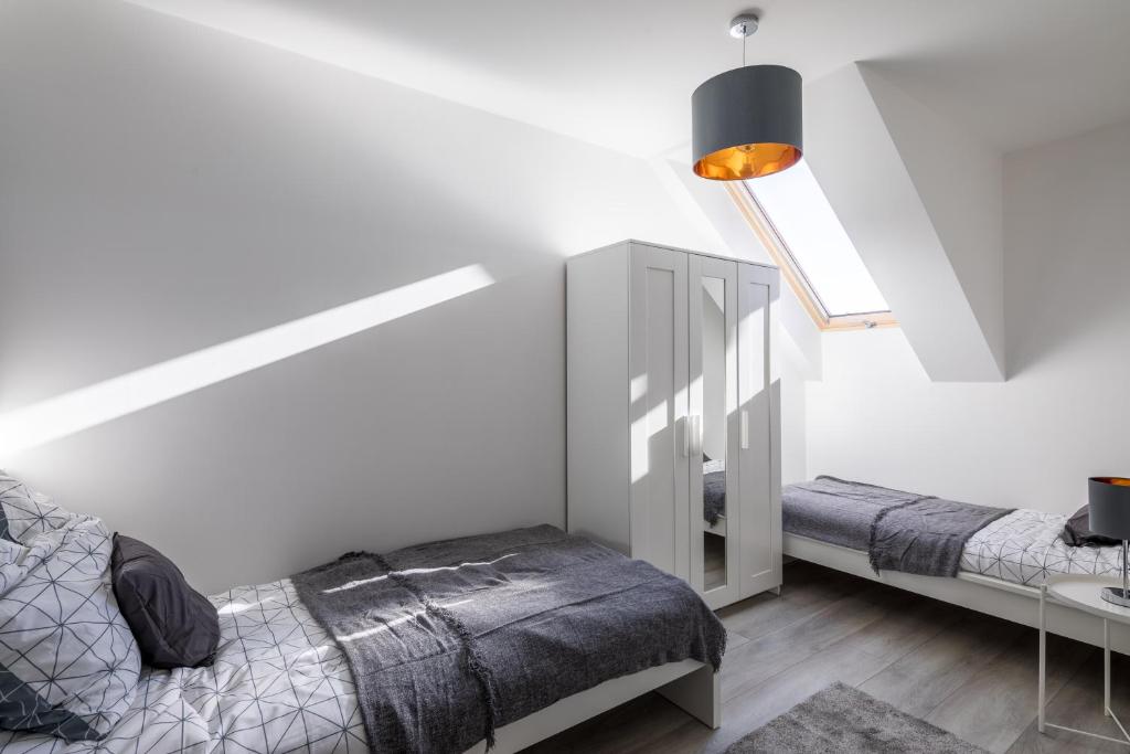 Postel nebo postele na pokoji v ubytování Stafétaház Apartmanok