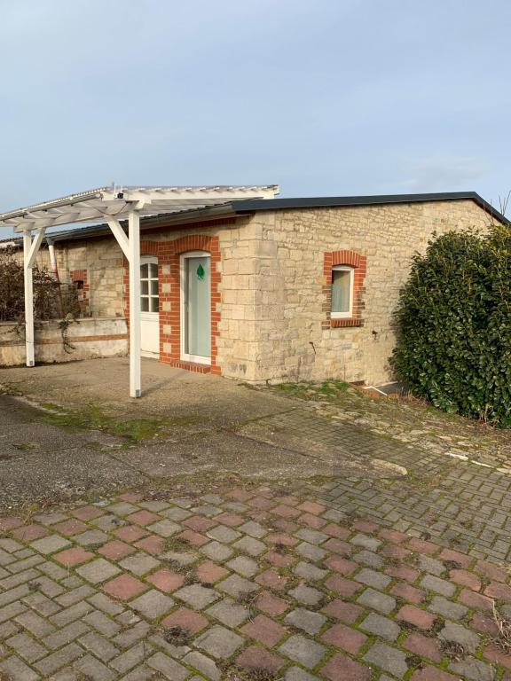 a brick house with a roof and a driveway at Lindenhof in Hecklingen