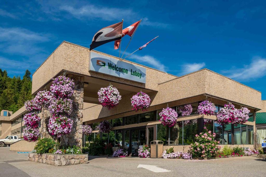 a shopping center with flowers in front of it at Sandman Hotel Castlegar in Castlegar