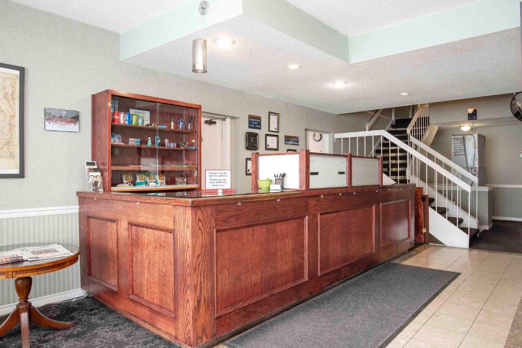 a room with a wooden counter with a staircase at Sandman Inn Princeton in Princeton