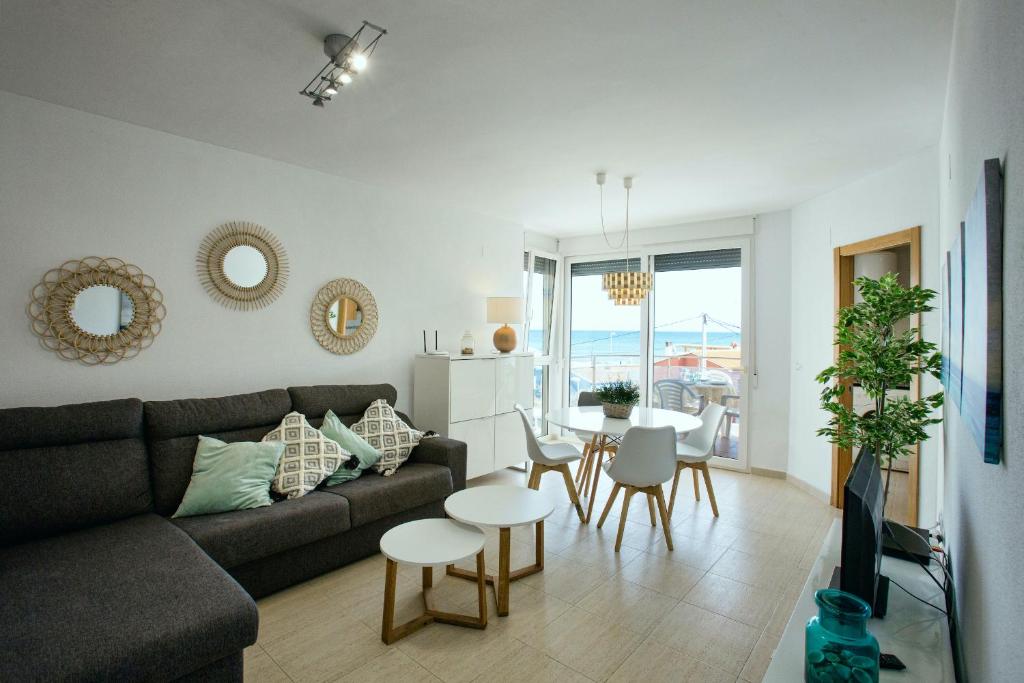 a living room with a couch and a table at Zurich 47 by homeprive in Denia