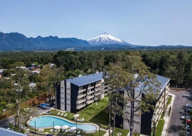 an aerial view of a resort with a snow covered mountain at Depto en Condominio Pucón in Pucón