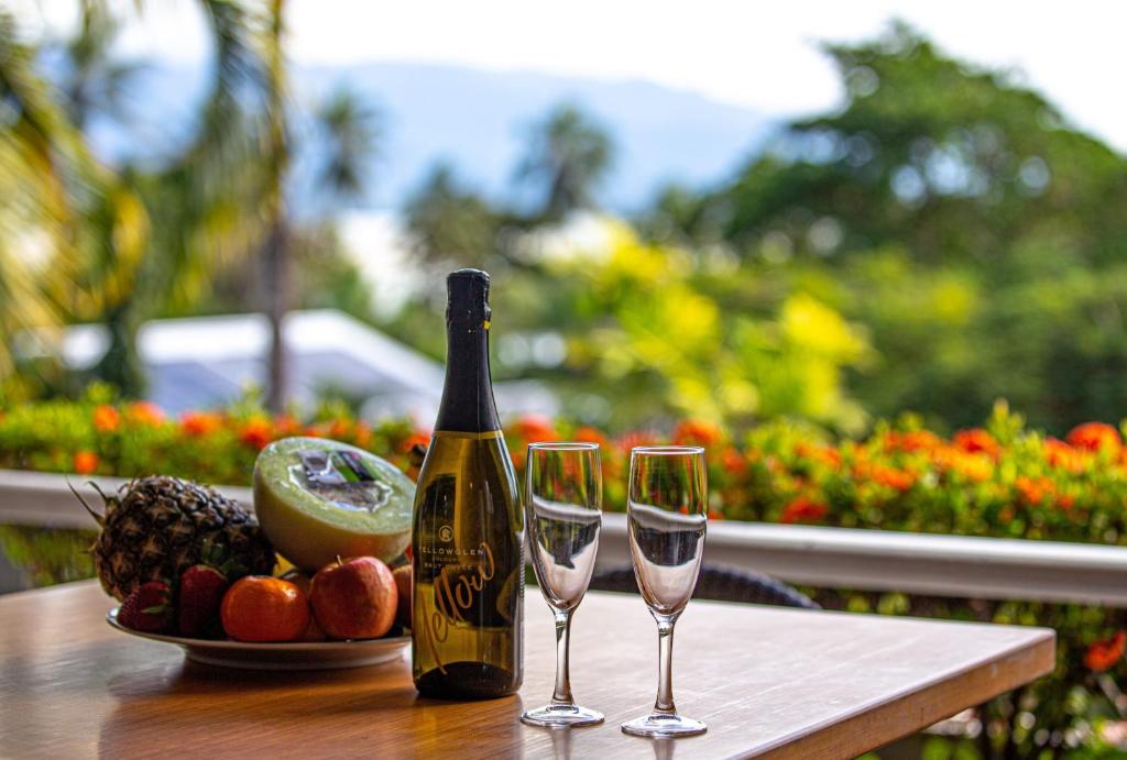 a bottle of champagne and two glasses on a table at Port Douglas Penthouse Suite in Port Douglas
